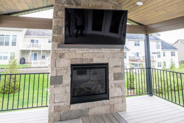 California Custom Decks custom deck with stone fireplace in Deckorators Voyage decking in Tundra color