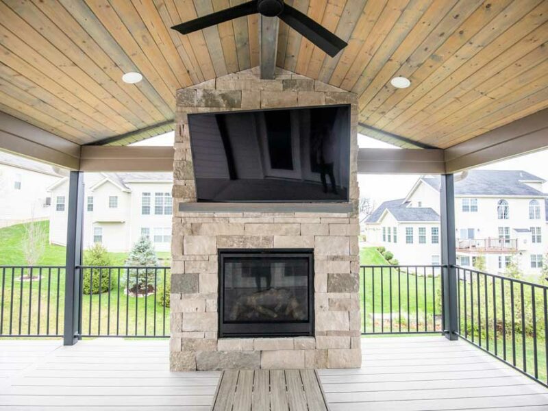 California Custom Decks custom deck with stone fireplace in Deckorators Voyage decking in Tundra color