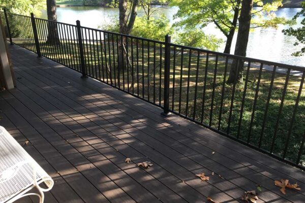 Open deck with black railing by water in Chesterfield, MO