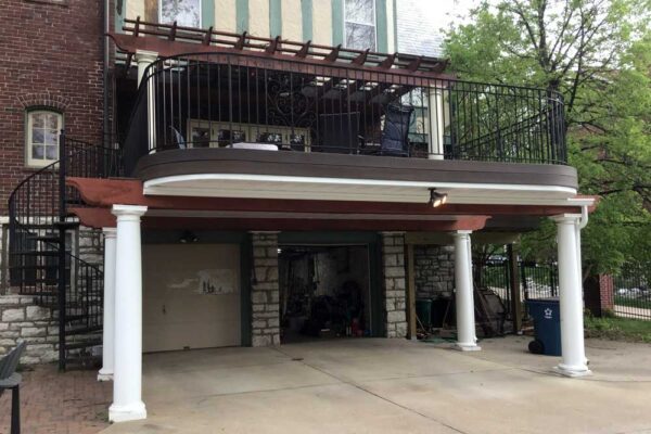 Curved open deck with pergola, spiral staircase, and garage underneath in Clayton, MO