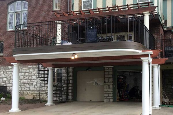 Curved open deck with pergola and garage underneath in Clayton, MO