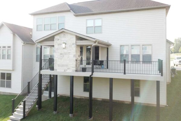 Covered deck with stone fireplace in Des Peres, MO