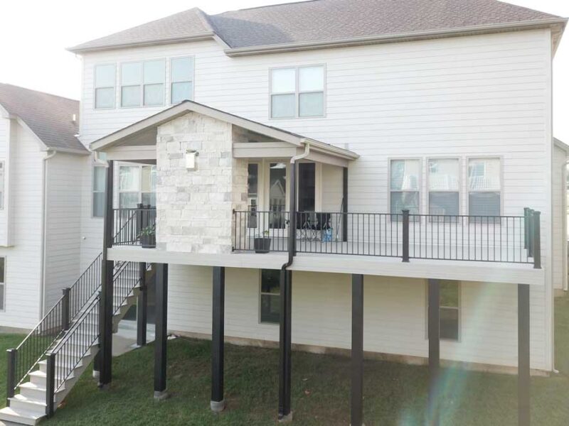 Covered deck with stone fireplace in Des Peres, MO
