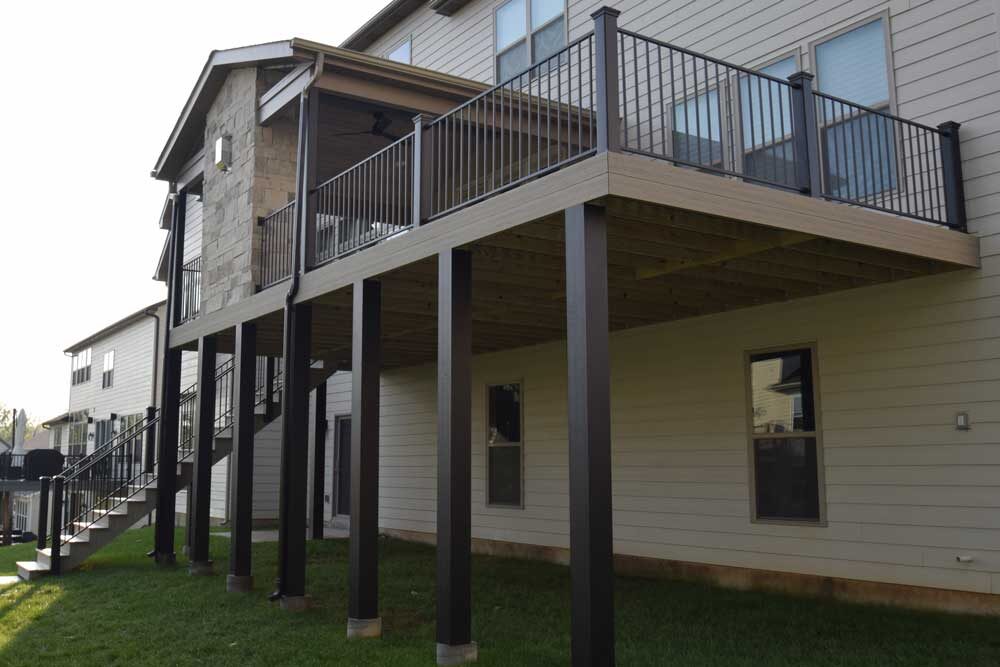 Covered deck with stone fireplace in Des Peres, MO