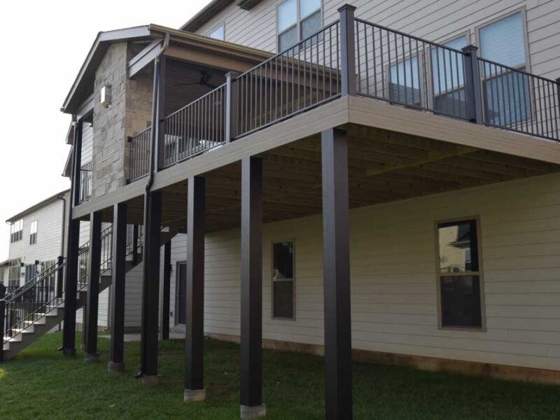Covered deck with stone fireplace in Des Peres, MO