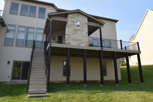 Covered deck with stone fireplace in Des Peres, MO