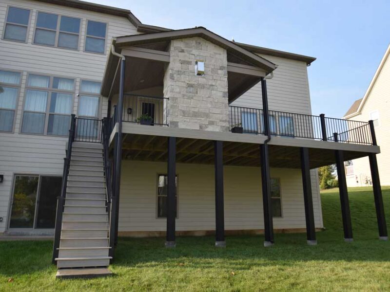 Covered deck with stone fireplace in Des Peres, MO