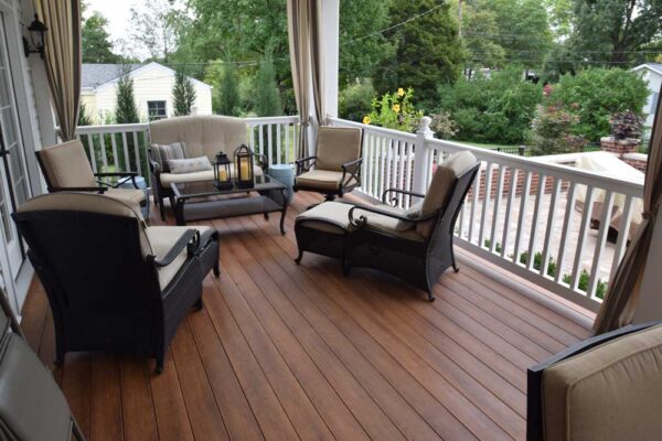 Custom deck with white rails and tie back curtains in Des Peres, MO