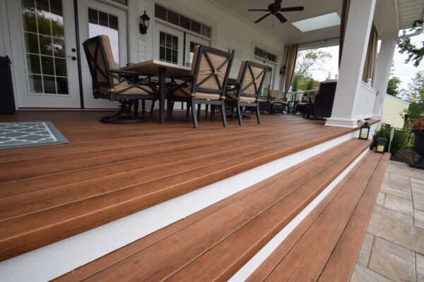 Covered deck with white rails and tie back curtains in Des Peres, MO