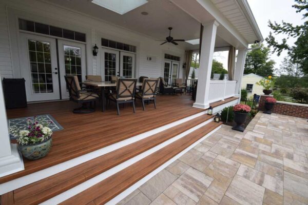 Covered deck with white rails and tie back curtains in Des Peres, MO