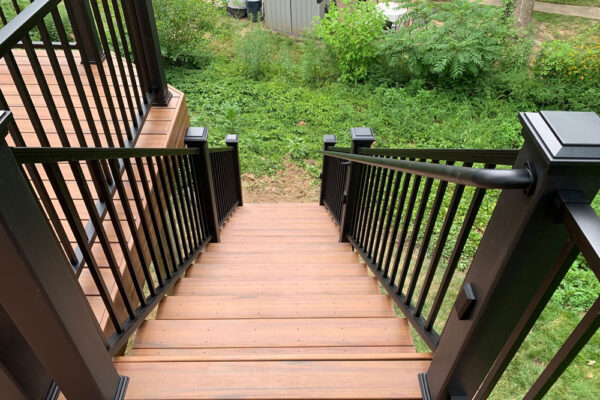 Composite wood deck stairs with black railing in Kirkwood, MO