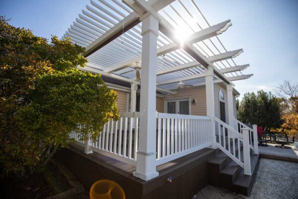 White pergola on top of a dark composite wood deck in Manchester, MO