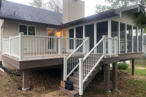 Screen room and composite wood deck with white railings in Manchester, MO