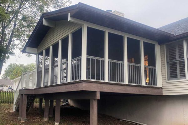 Screen room and composite wood deck with white railings in Manchester, MO