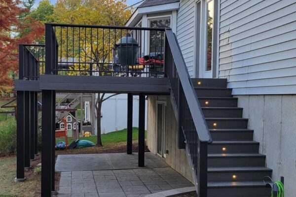 Dark wood open deck with stair lights and black railing in Manchester MO