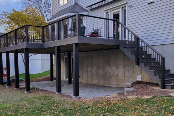 Dark wood open deck with stair lights and black railing in Manchester MO