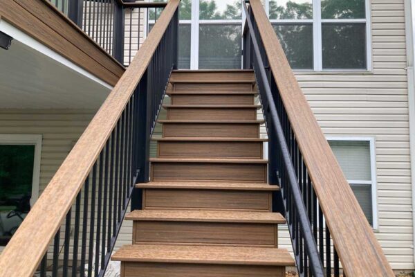 Custom composite wood deck stairs and black railing in Sunset Hills, MO