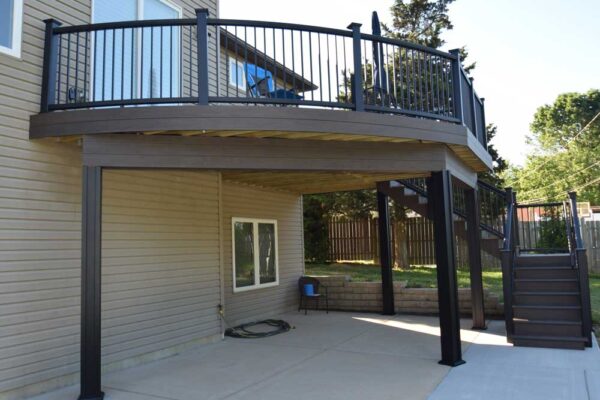 Custom composite deck and stairs with black railing in Sunset Hills, MO