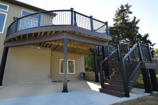 Custom composite deck and stairs with black railing in Sunset Hills, MO