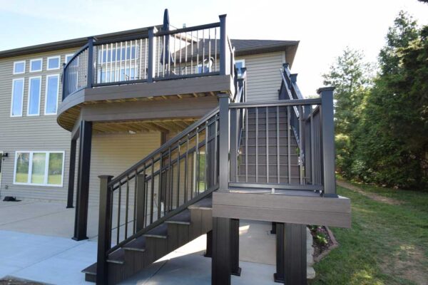 Custom composite deck and stairs with black railing in Sunset Hills, MO