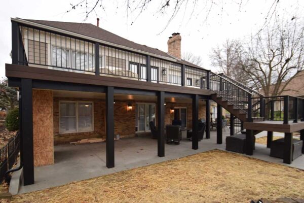 Custom open deck with black railing and under deck patio in Sunset Hills, MO