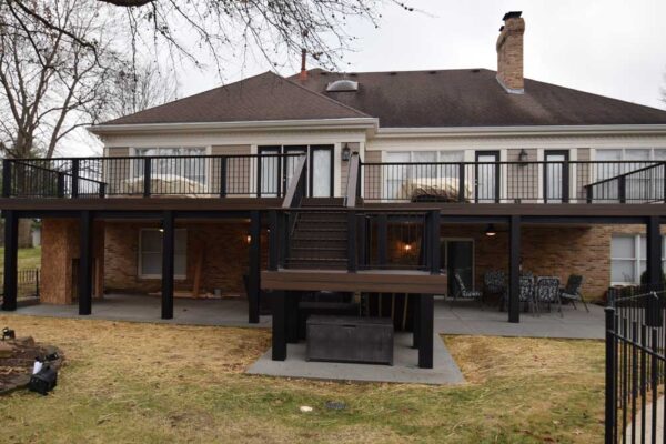 Custom open deck with black railing and under deck patio in Sunset Hills, MO