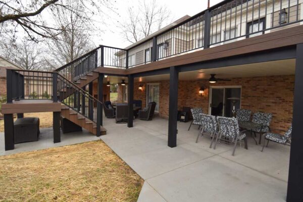 Custom open deck with black railing and under deck patio in Sunset Hills, MO