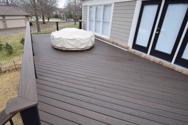 Custom open deck with black railing and under deck patio in Sunset Hills, MO