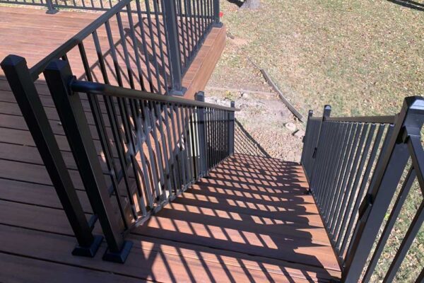 Deck stairs with black railing in Webster Groves, MO