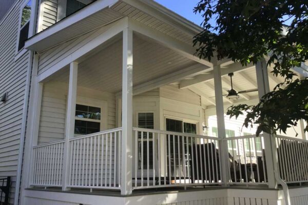 Covered deck with white railing in Webster Groves, MO