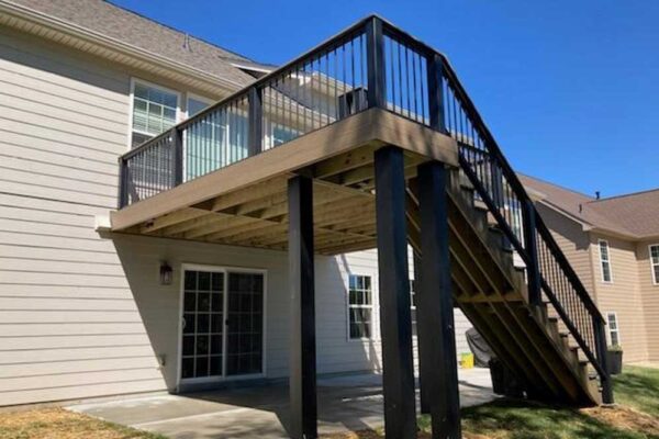 Composite wood open deck with black railing in Wildwood, MO