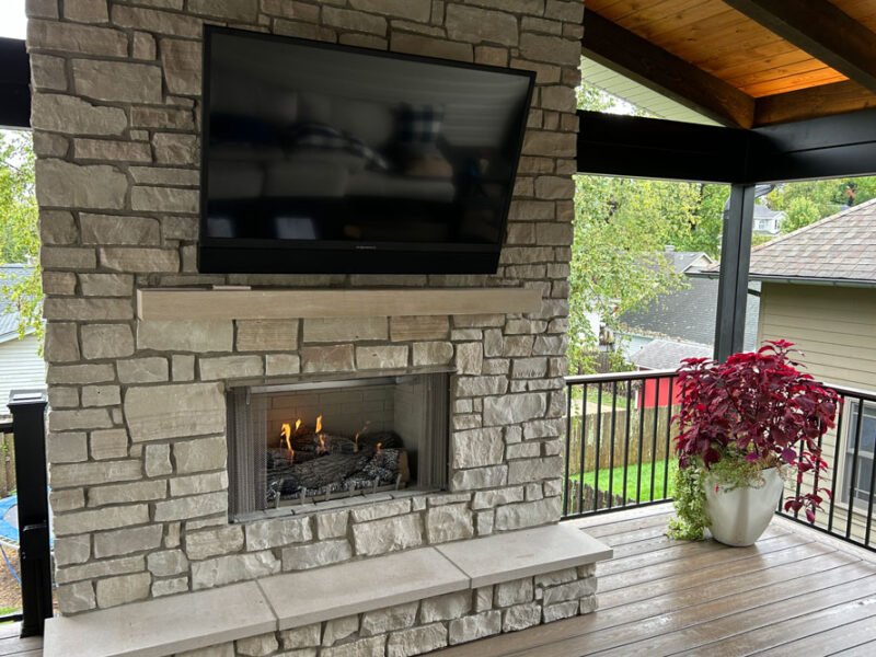 Stone fireplace with television